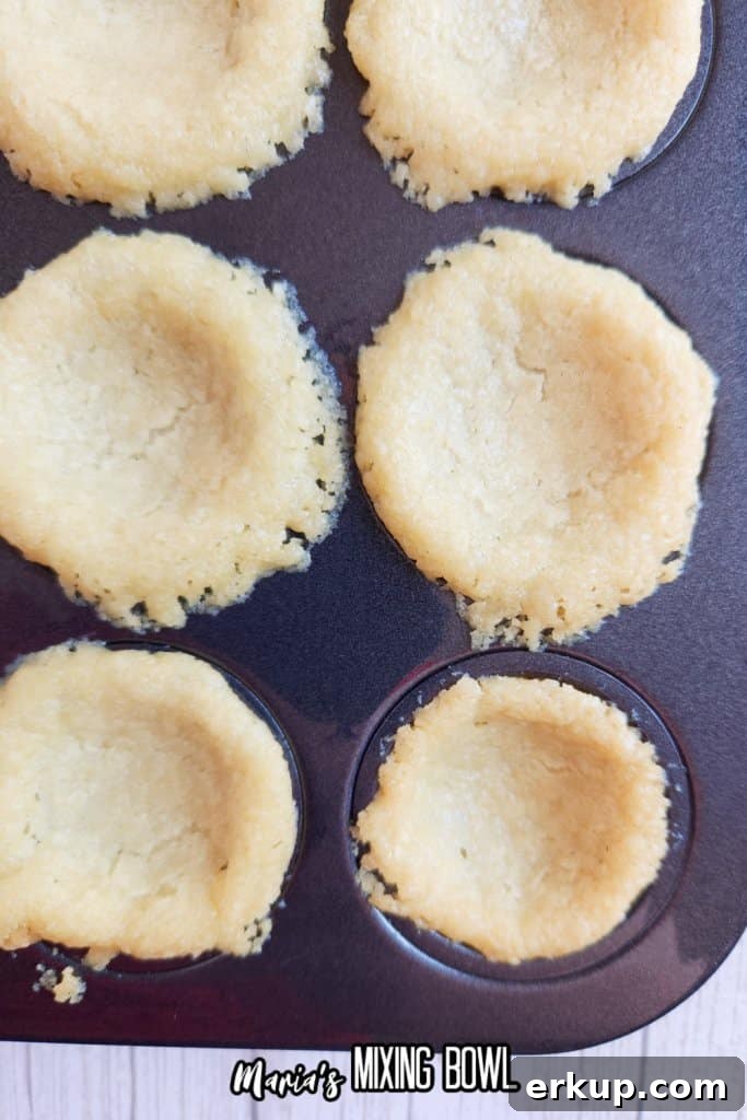 sugar cookie dough balls in a mini muffin pan