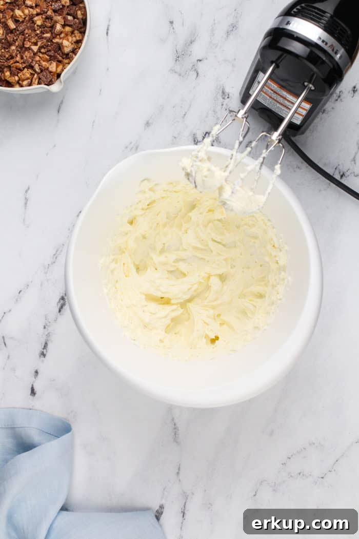 Cream cheese whipped in a white mixing bowl.