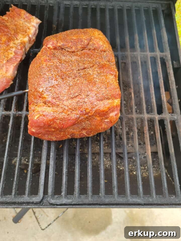 Smoked Pork Butt Recipe for Tender Pulled Pork 5 rubbed pork butt on smoker close to heat source
