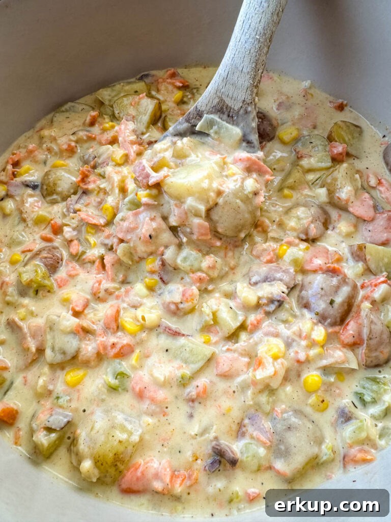 creamy salmon chowder with corn and potatoes in a Dutch oven