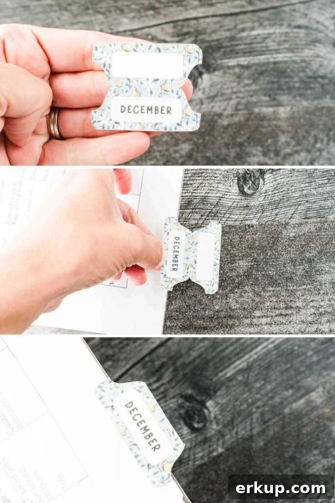 blue and yellow monthly sticker tabs being applied to page.