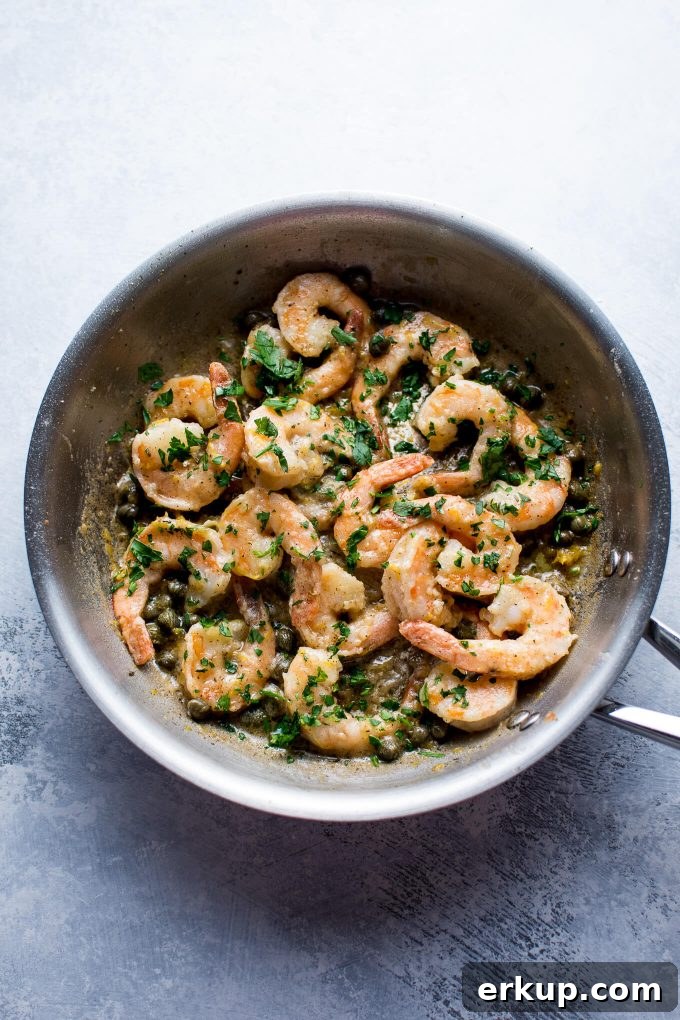 30-Minute Shrimp Piccata with Lemon Caper Sauce 3 metal skillet with shrimp, lemon, butter, and capers