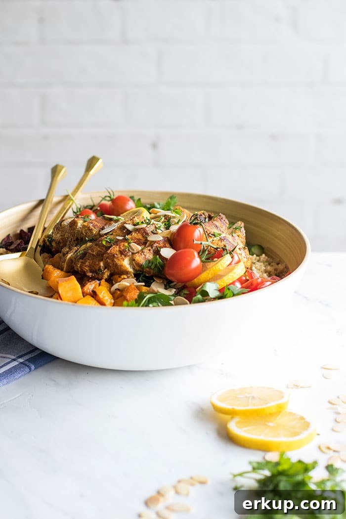 A bowl on a table filled with a Moroccan Chicken Quinoa Salad.