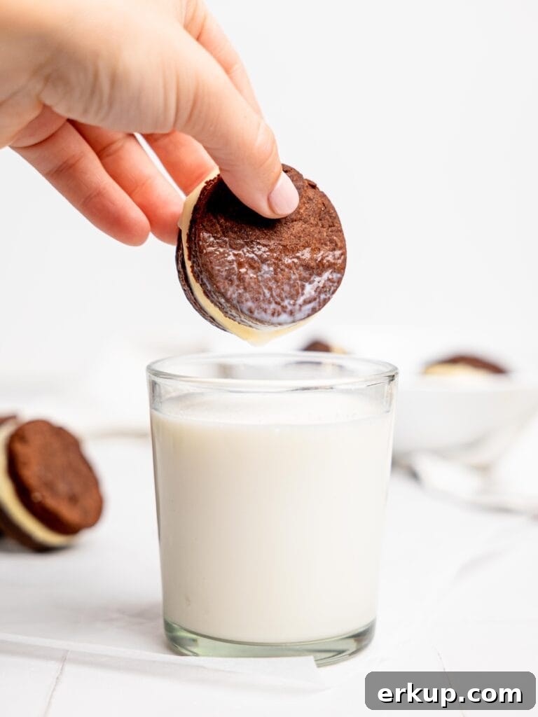 Homemade Oreos: 5-Ingredient Recipe 7 Dunking a homemade oreo in a glass of milk.