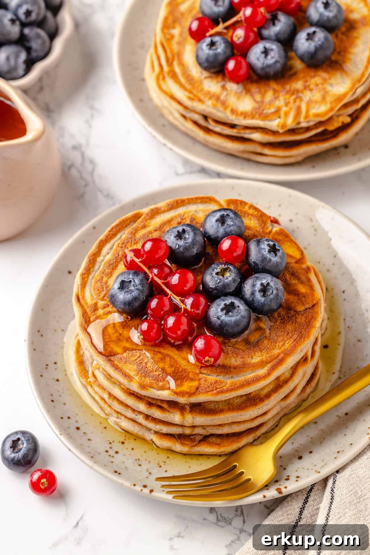 Plates of protein pancakes with berries on top