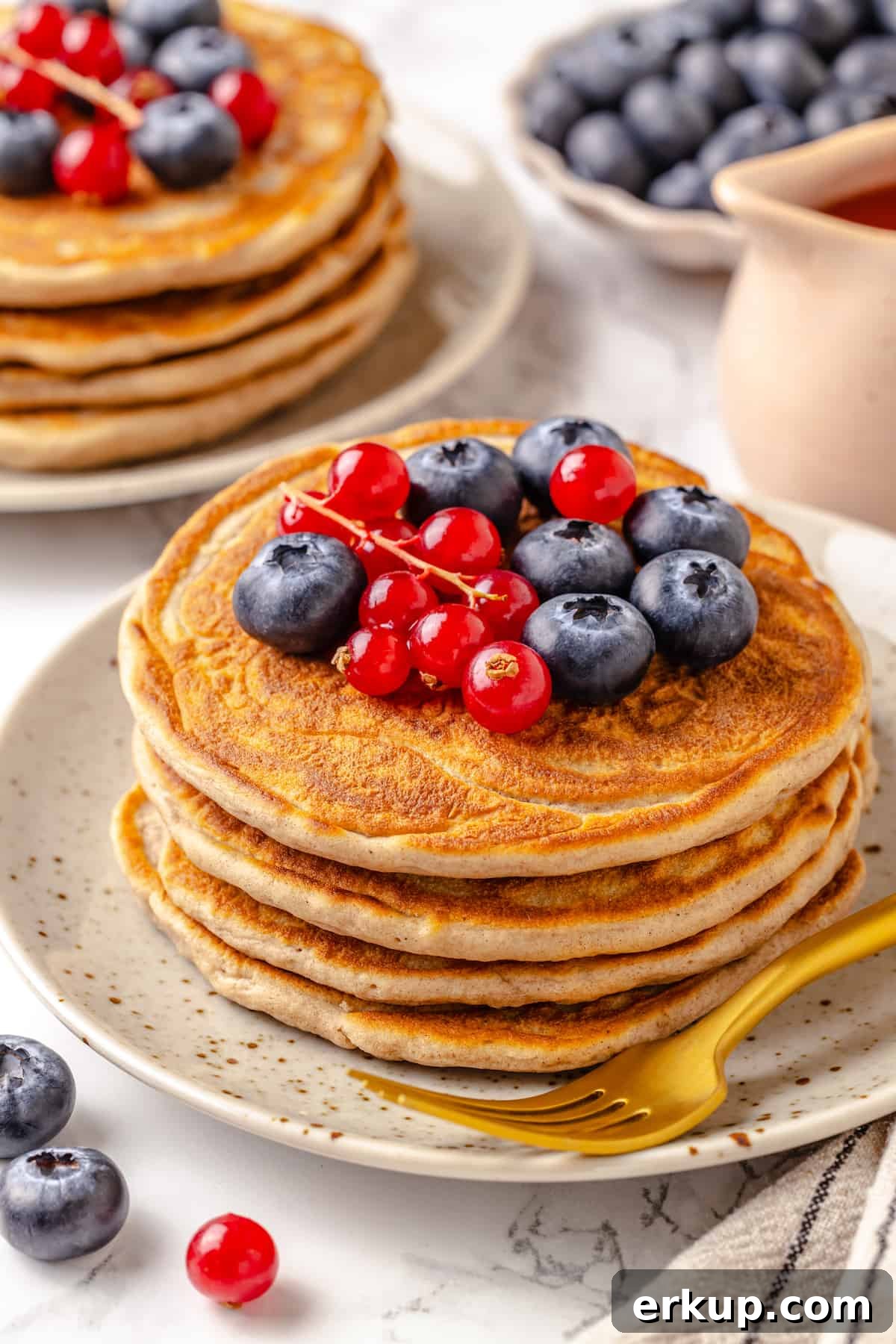 Stack of 4 protein pancakes topped with berries
