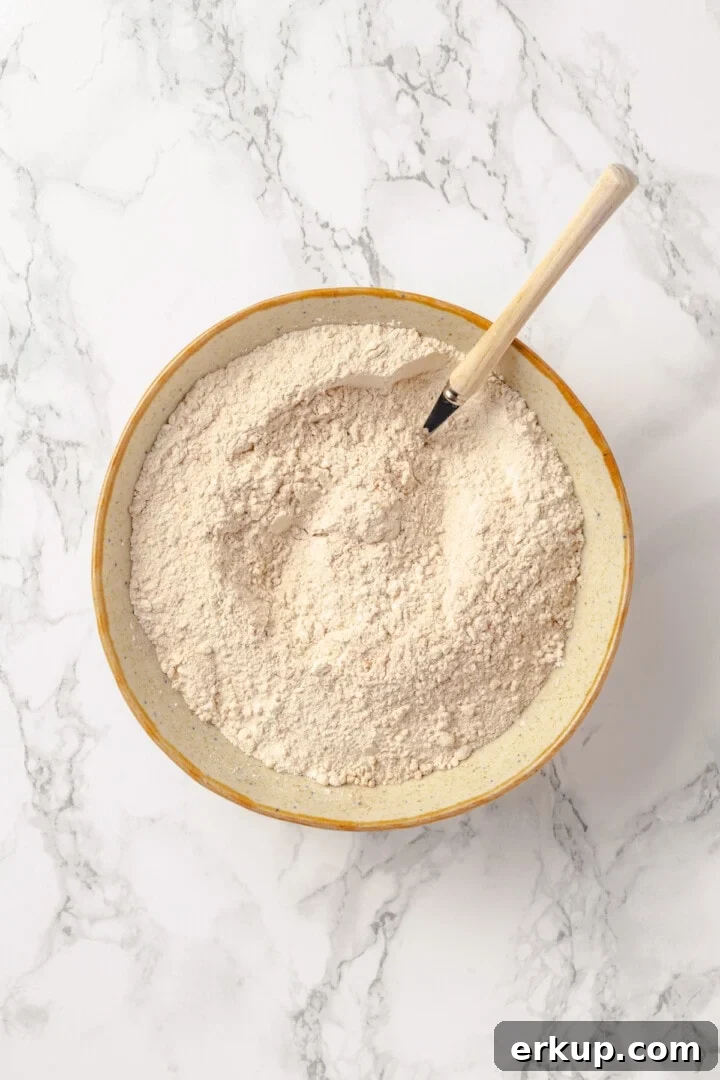 Overhead view of dry ingredients for protein pancakes in mixing bowl