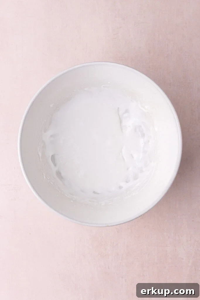 Silky Pourable Coconut Glaze for Cakes and Pastries 4 Coconut milk, coconut extract, and powdered sugar whipped together to make a simple glaze.