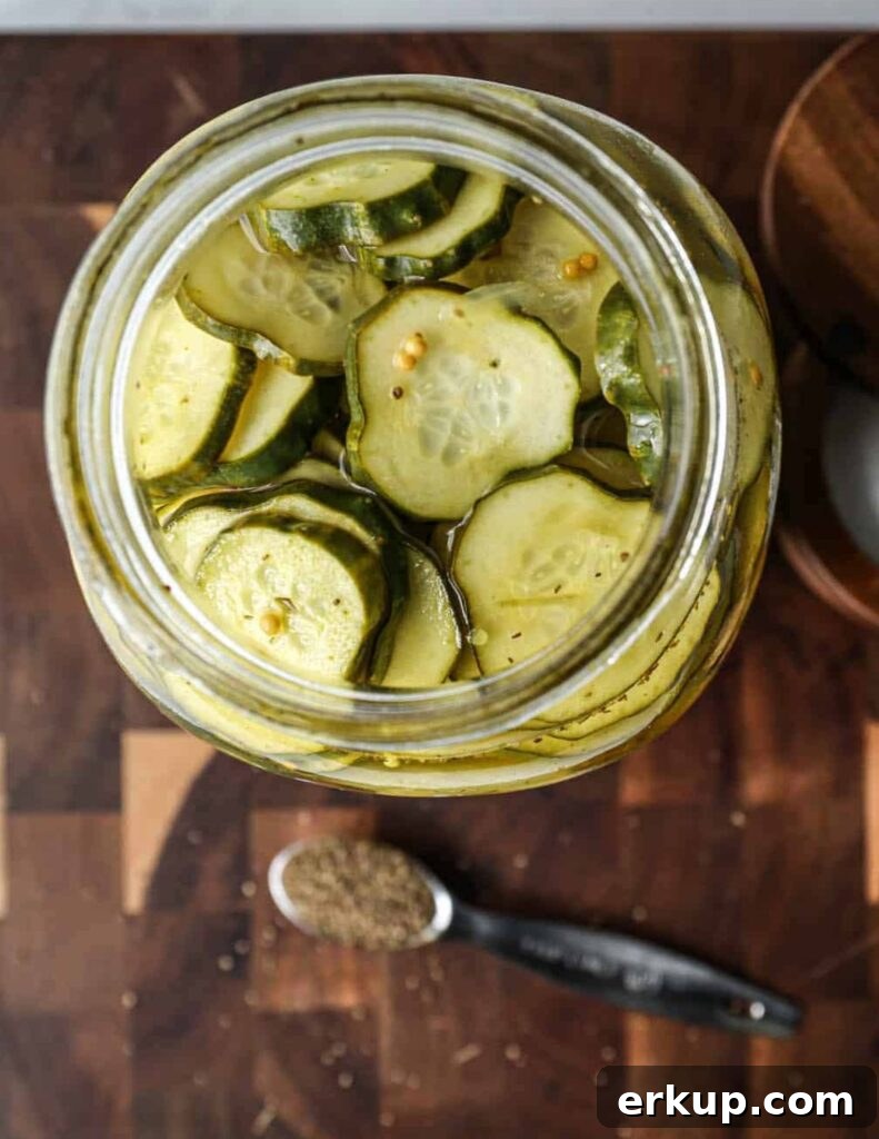 Jar with cucumber slices and onions ready for brine