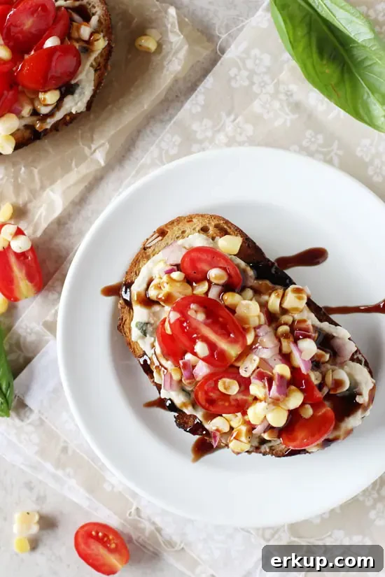 A Tomato White Bean Sandwich on a white plate drizzled with balsamic glaze.