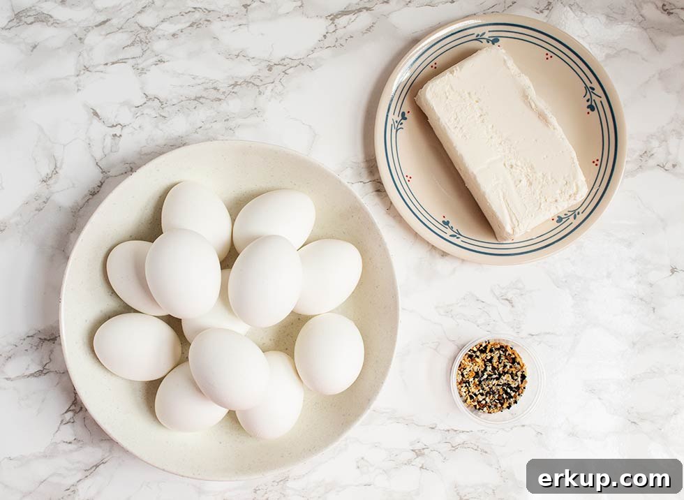 Keto Deviled Eggs with Everything Bagel Seasoning Recipe 3 overhead view of keto deviled eggs ingredients including cream cheese and seasoning in a small bowl