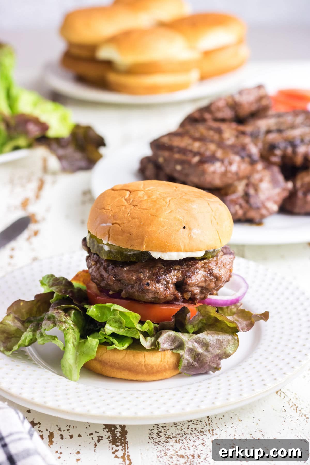 A finished hamburger on a plate.