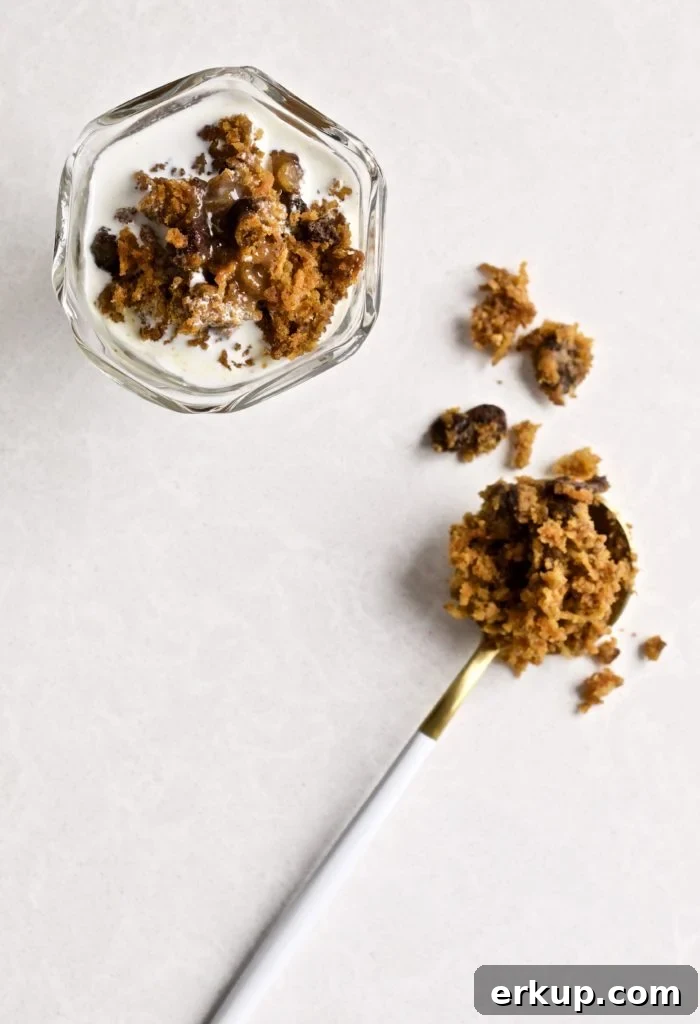 Steam carrot pudding with caramel sauce in a small glass and on a spoon.