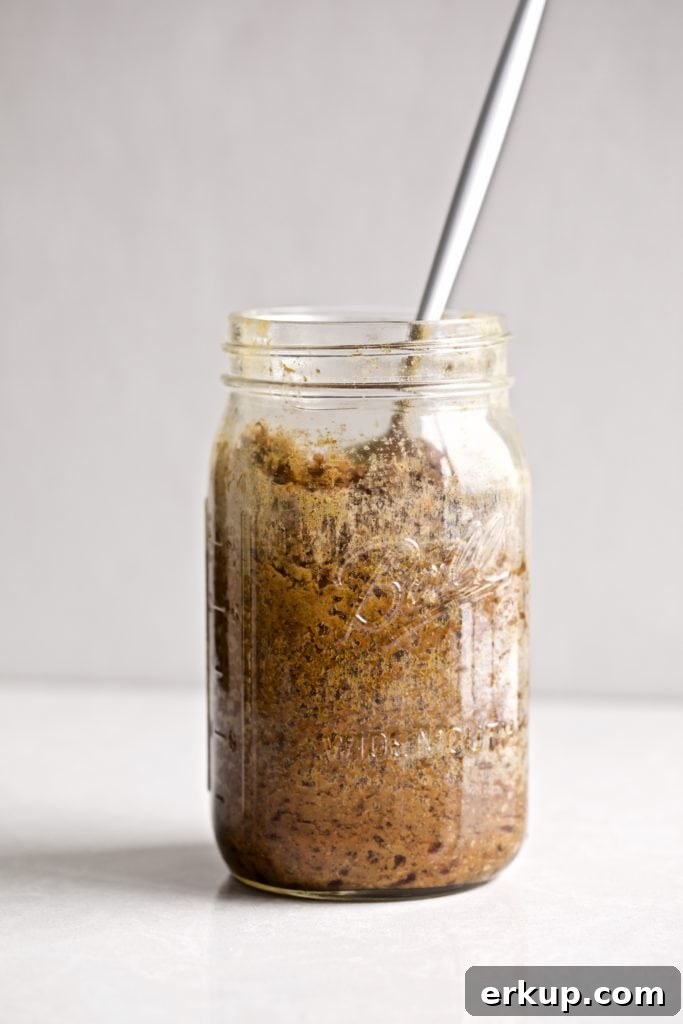 Spoon in a jar of steamed carrot pudding.