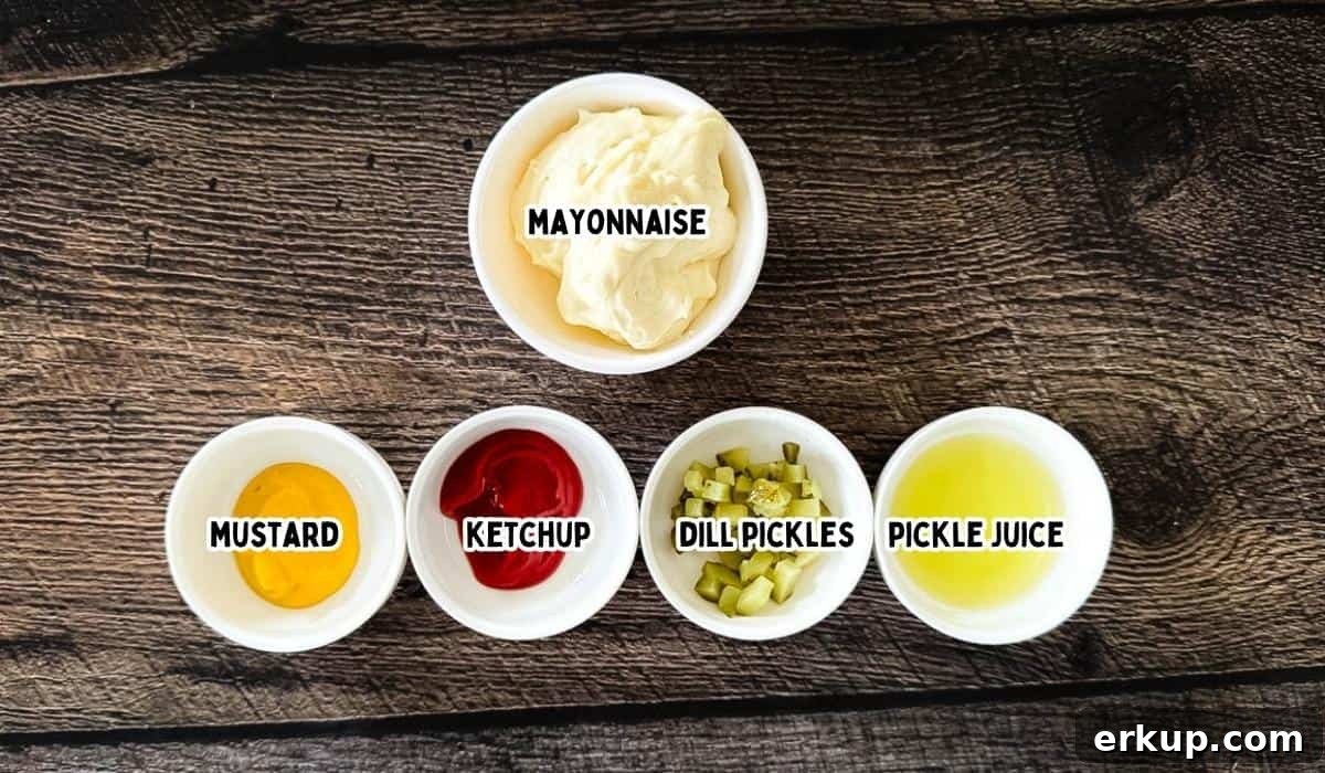 Ingredients for homemade smashburger sauce arranged on a wooden surface, including mayo, ketchup, mustard, pickle juice, and pickles.