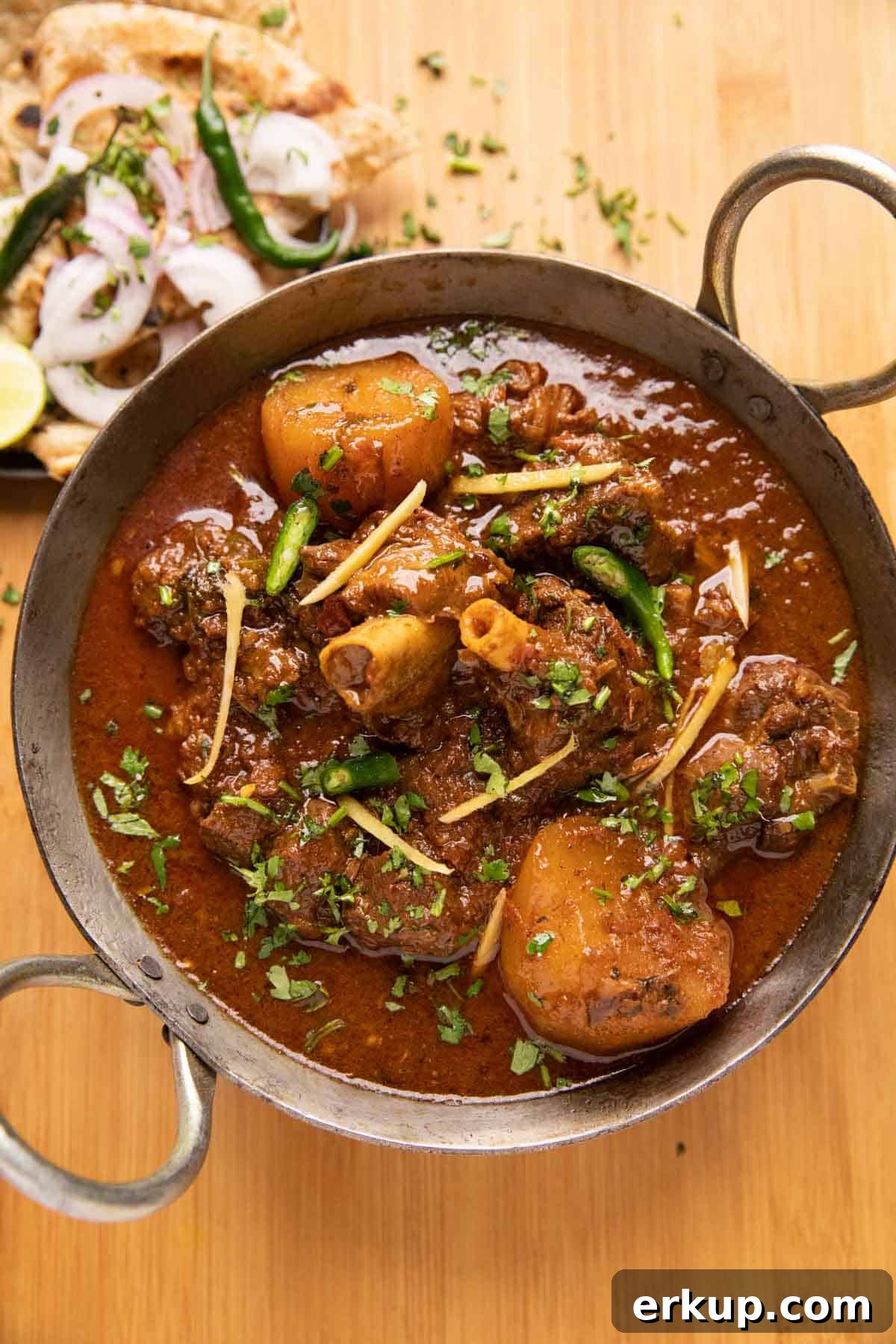 Pressure Cooker Mutton Curry: Lamb Curry Recipe 2 Mutton Curry served in a kadhai with tandoori roti and onions on the side