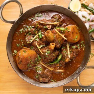 Pressure Cooker Mutton Curry: Lamb Curry Recipe 3 Mutton Curry served in a kadhai with tandoori roti and onions on the side