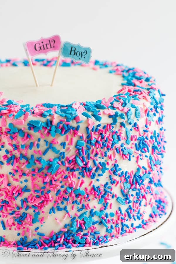 Tall 6-layer white cake covered with sweet and tangy cream cheese frosting and filled with colorful candies and sprinkles inside. Deliciously fun way to reveal the gender of a new bundle of joy!