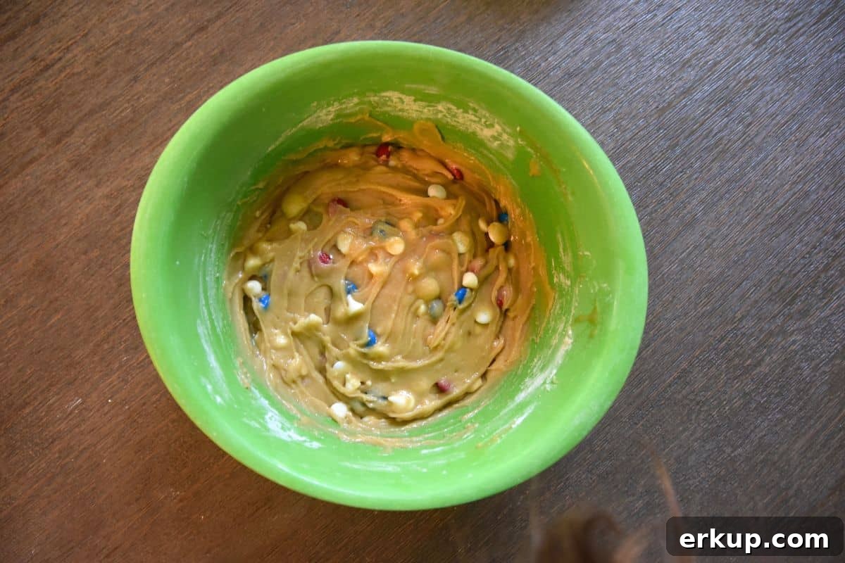 Red, White and Blue Blondies Recipe for Fourth of July 8 blondie batter M&Ms and white chocolate chips in bowl
