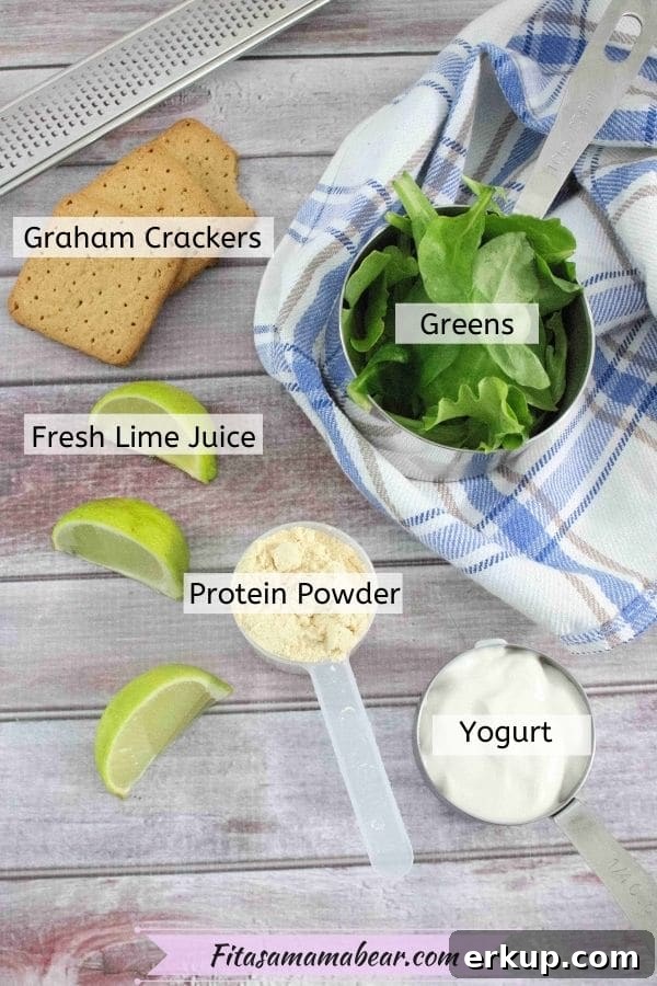Multiple ingredients in steel measuring cups like spinach, protein powder and yogurt with fresh sliced limes around it and all ingredients labeled.