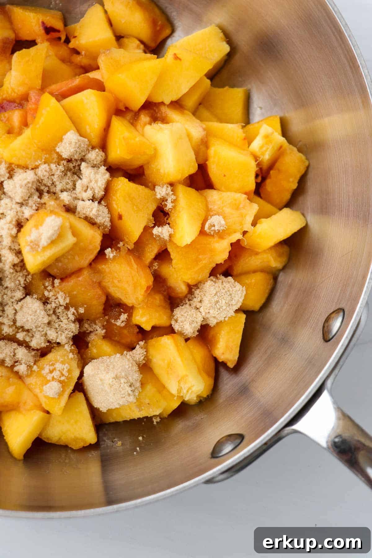Peaches and brown sugar in a saucepan.