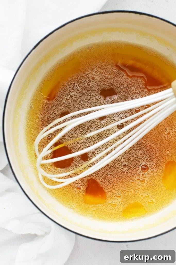 Close up overhead view of browned butter in a white saucepan