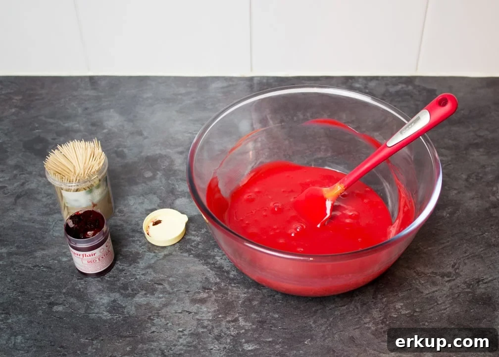 Caramel coloured with red food gel in a glass bowl