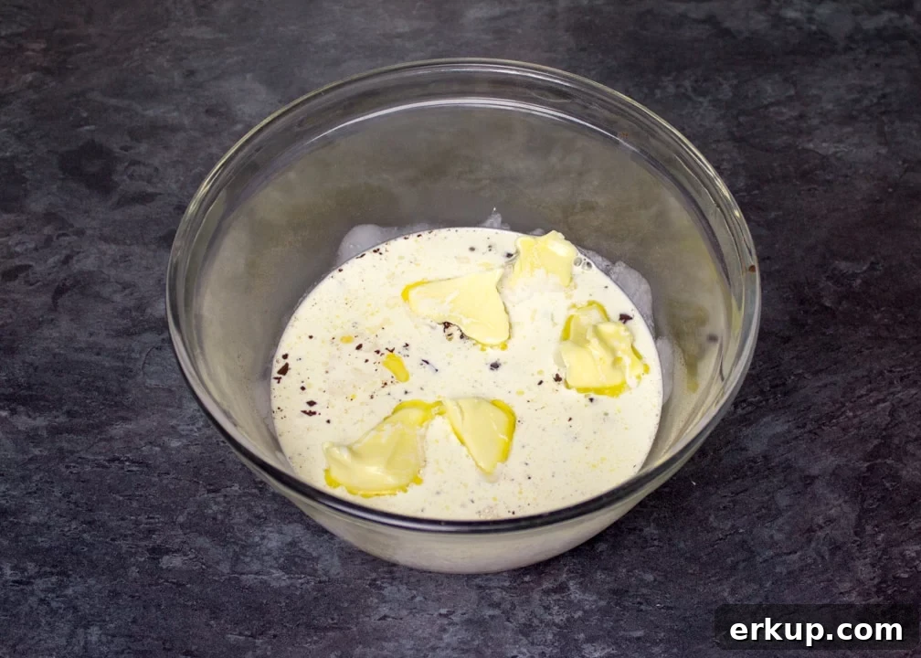 hot cream over butter & dark chocolate in a glass bowl