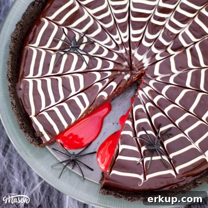 Halloween Dessert | No Bake Bloody Spider Web Chocolate Tart on a plate with plastic spiders