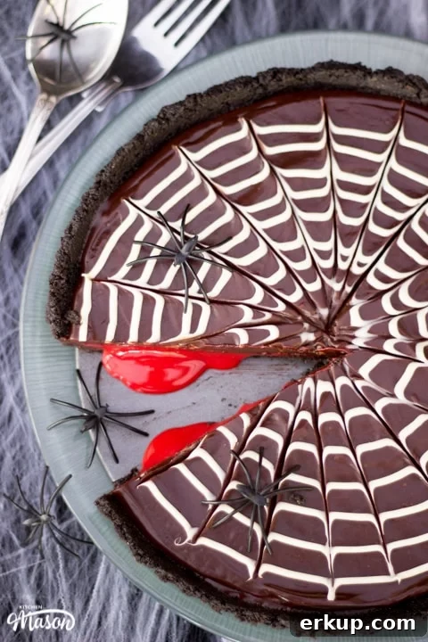 Halloween Dessert | No Bake Bloody Spider Web Chocolate Tart on a plate with plastic spiders