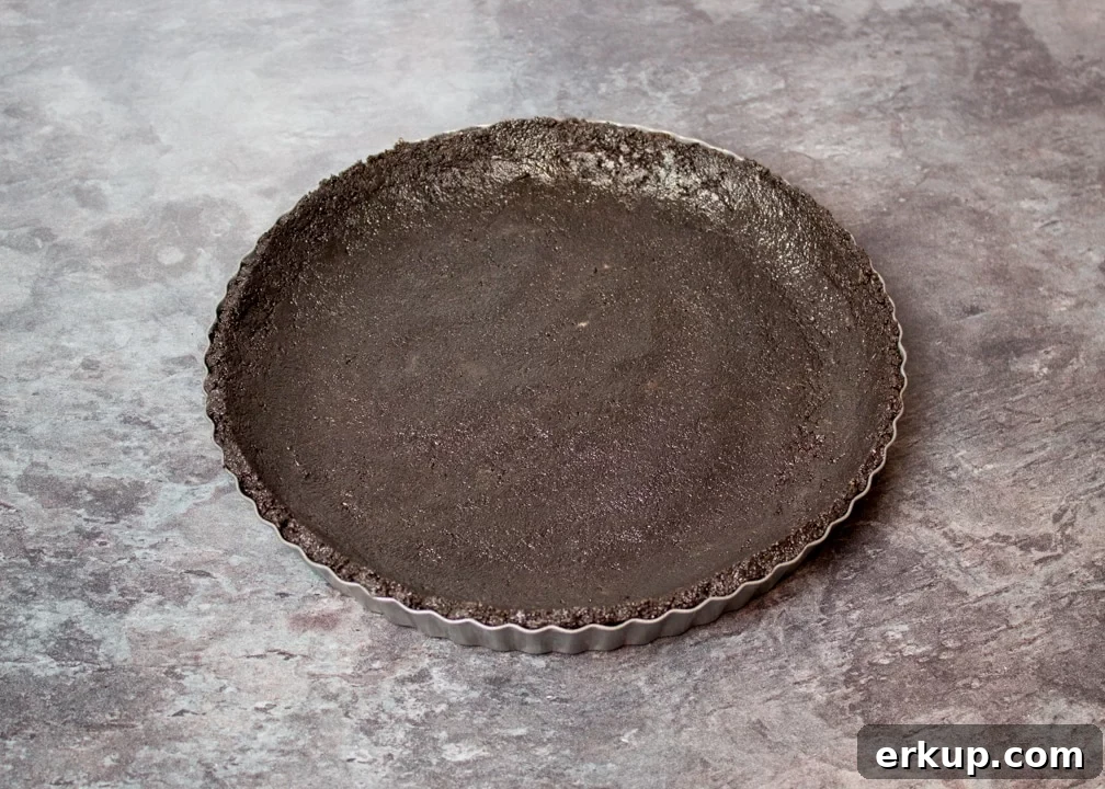 Oreo biscuit crumbs pressed into a fluted tin