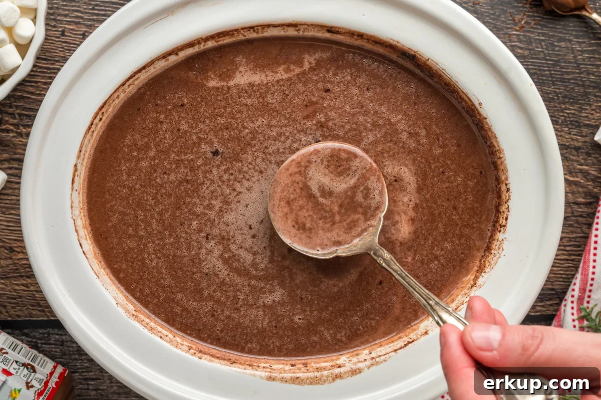 hot chocolate with Nutella in a white slow cooker.