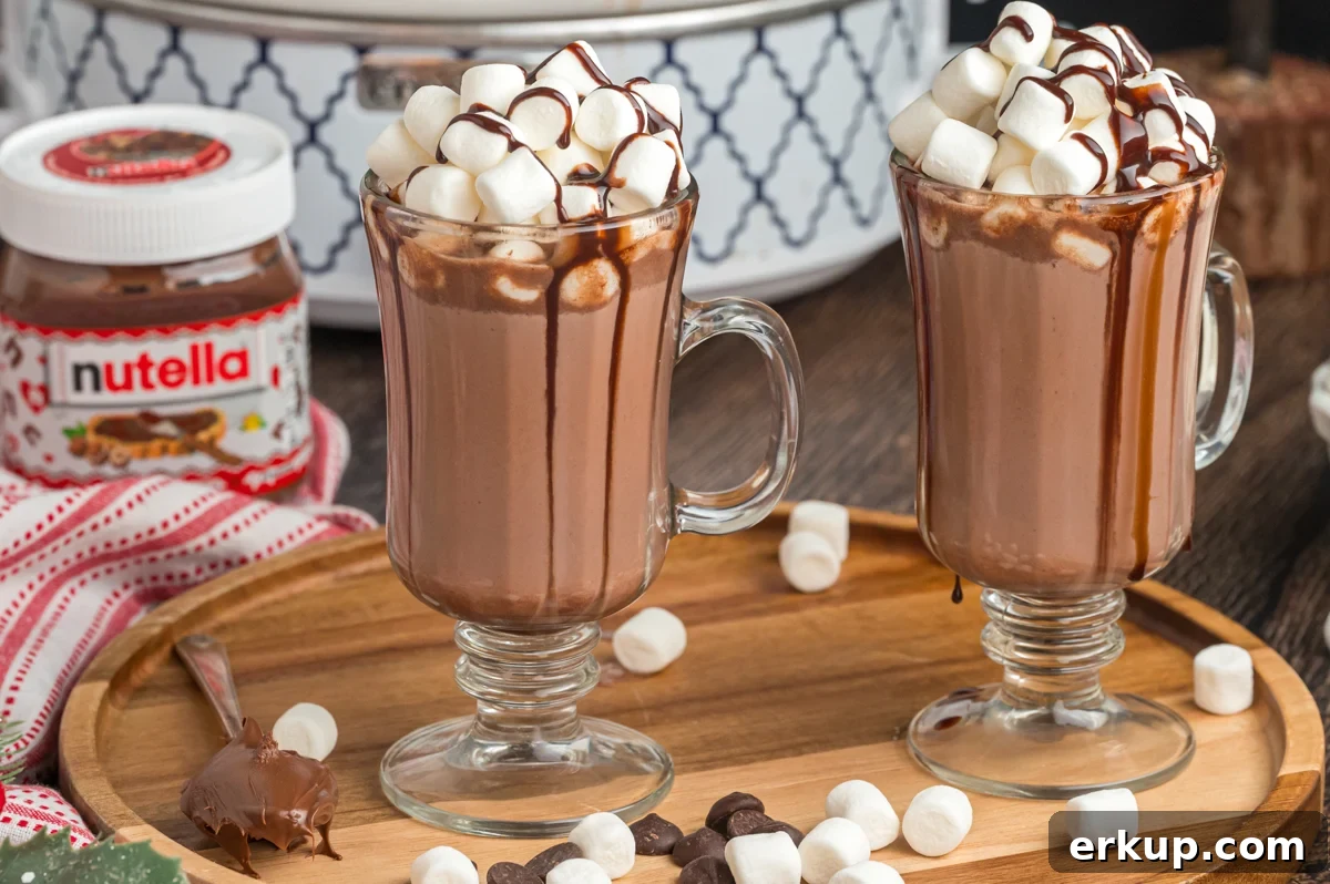 nutella hot chocolate in clear mugs with mini marshmallows.