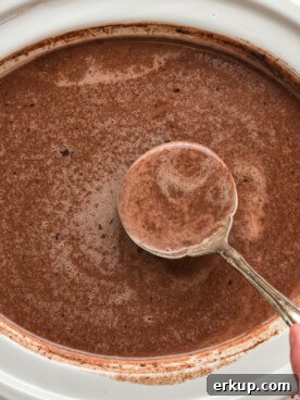 hot chocolate with Nutella in a white slow cooker.