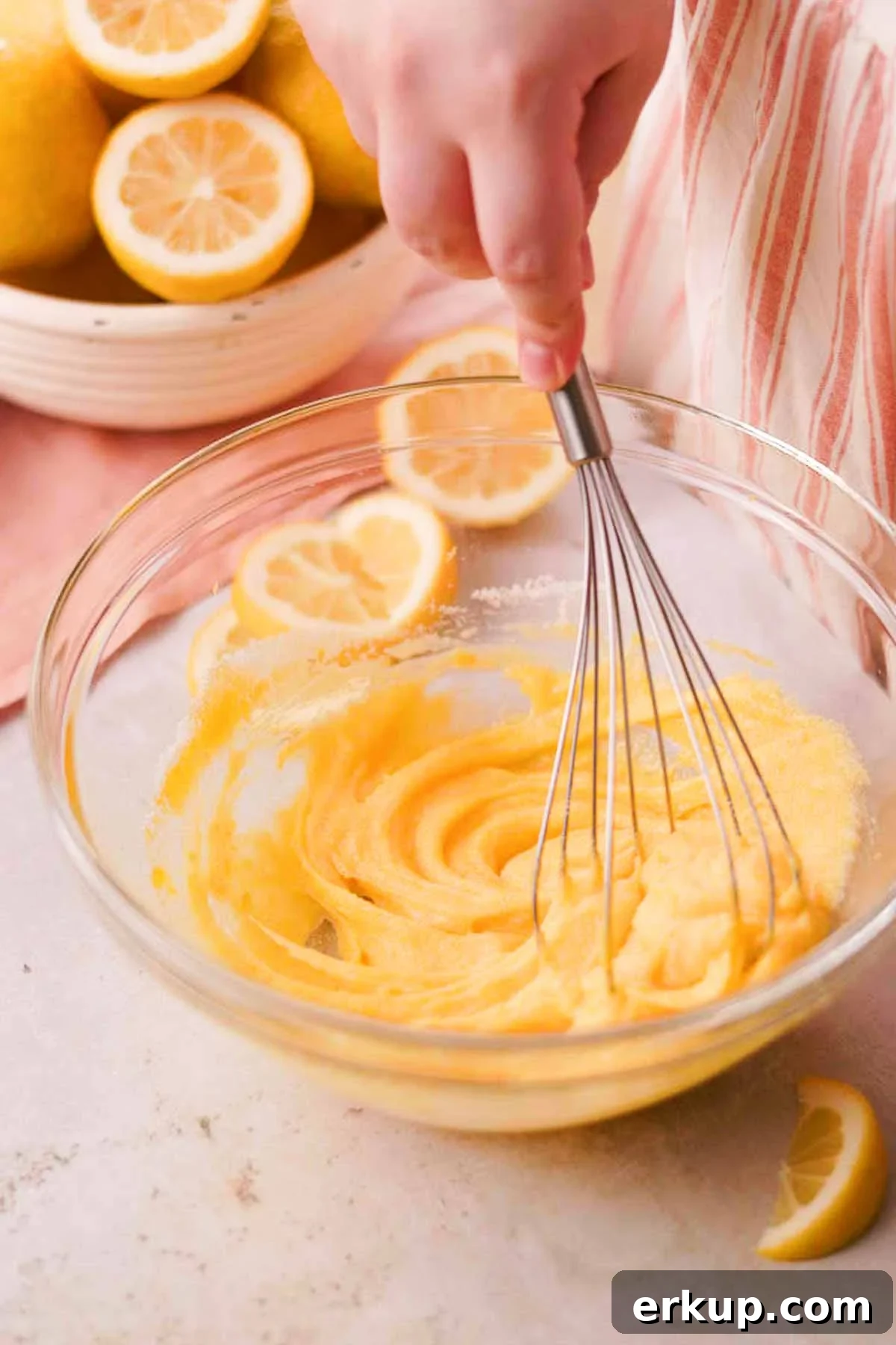 Zesty Lemon White Chocolate Cookies Recipe 6 whisking lemon sugar, egg, and yolk in a glass bowl with a metal whisk