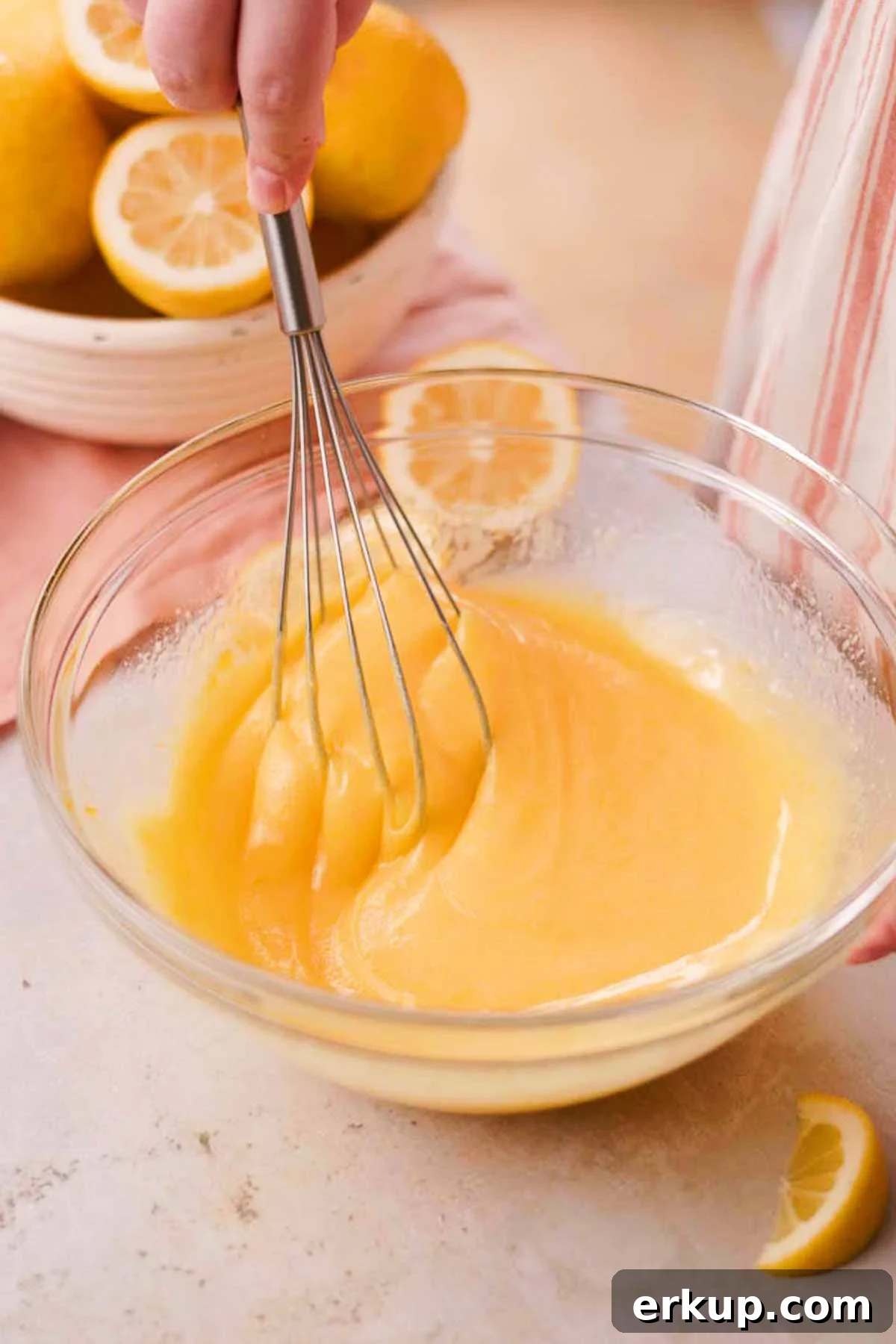 Zesty Lemon White Chocolate Cookies Recipe 7 whisking lemon sugar, egg, yolk, and butter in a glass bowl with a metal whisk