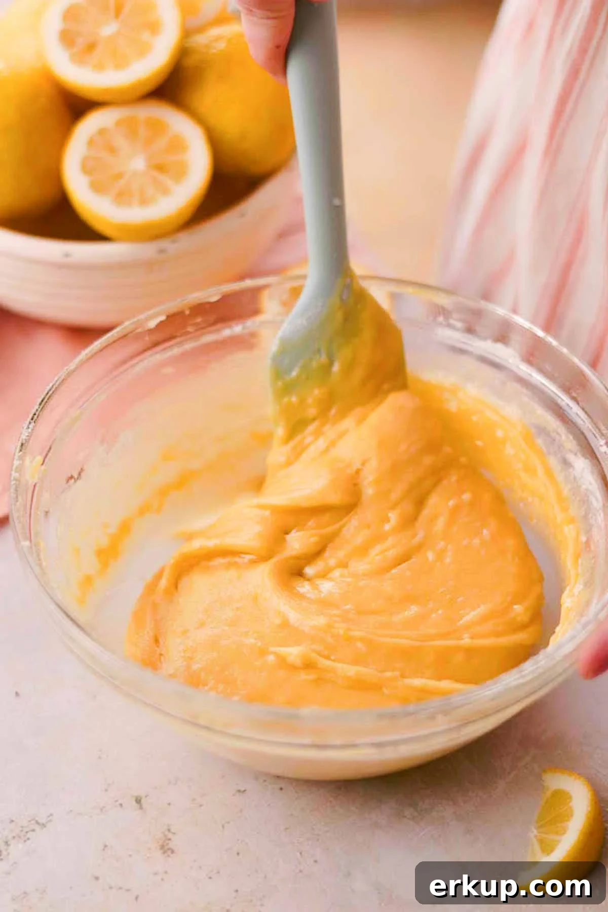 Zesty Lemon White Chocolate Cookies Recipe 8 stirring lemon cookie dough in a large glass bowl with a spatula