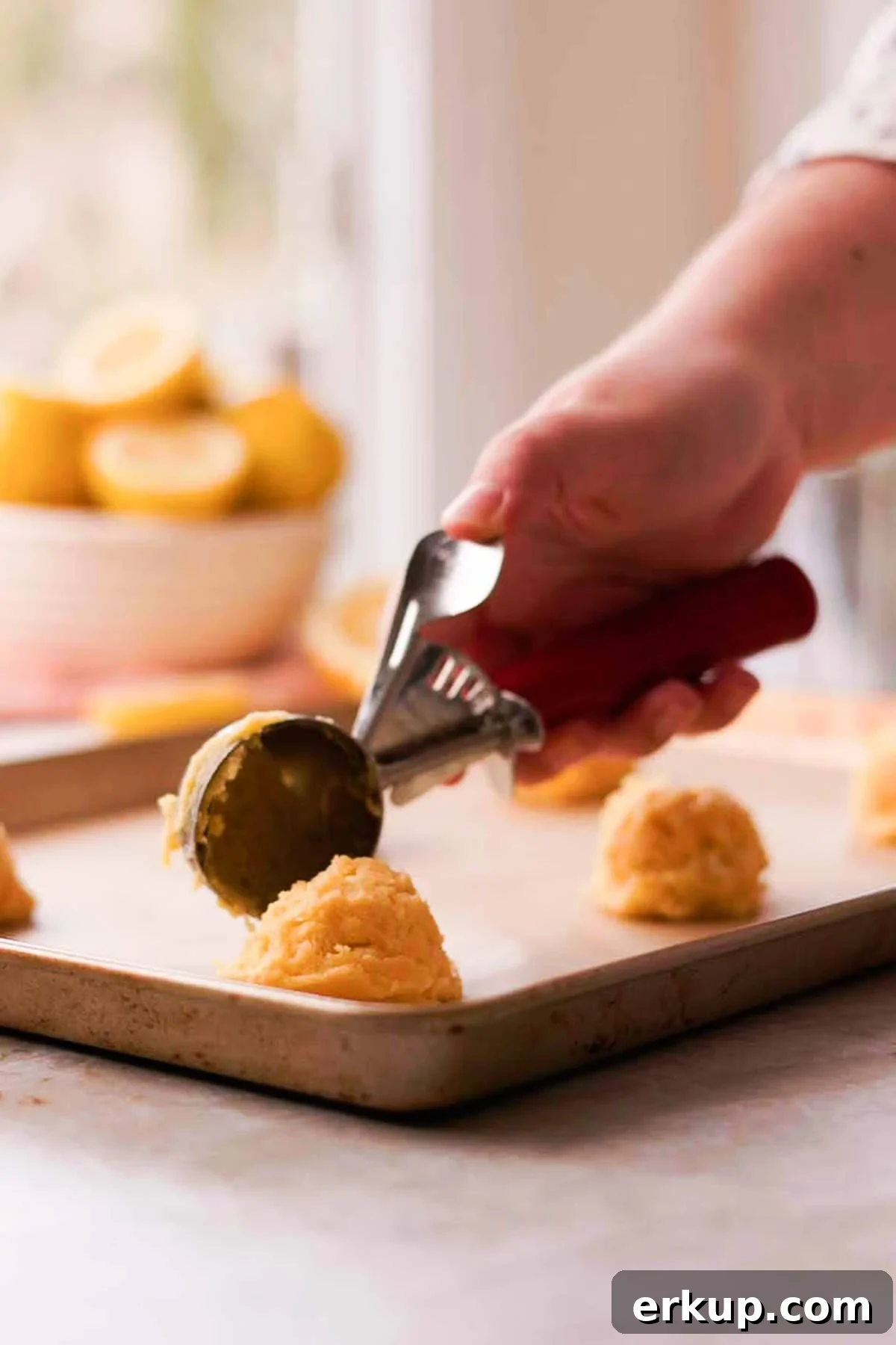 Zesty Lemon White Chocolate Cookies Recipe 10 scooping lemon cookie dough onto parchment paper lined baking sheet
