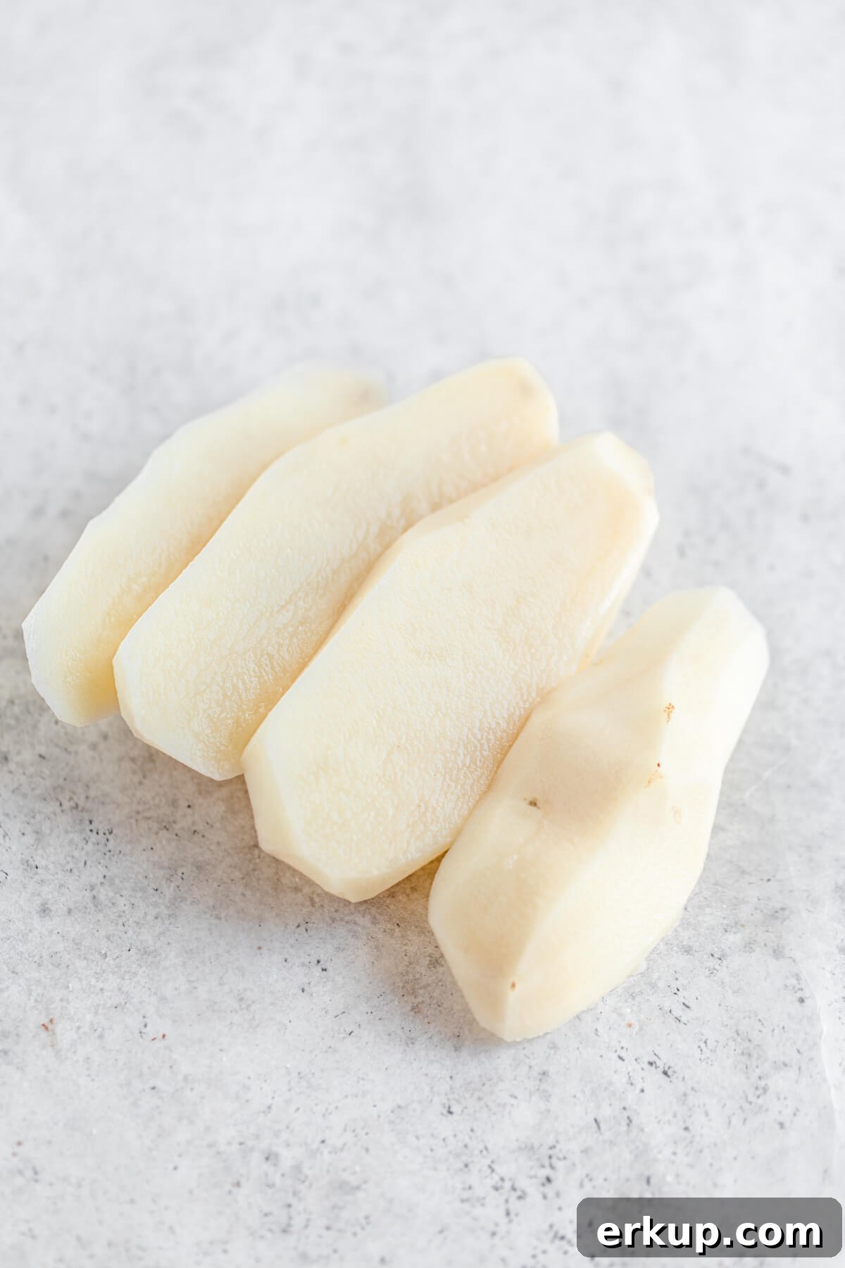 skinned potato sliced into four portions