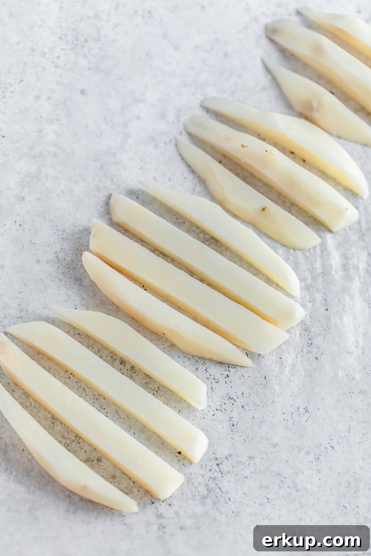 skinned potatoes cut into French fry sticks