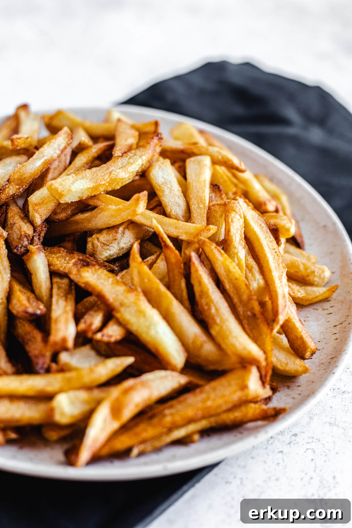 close up of cooked French fries on a plate