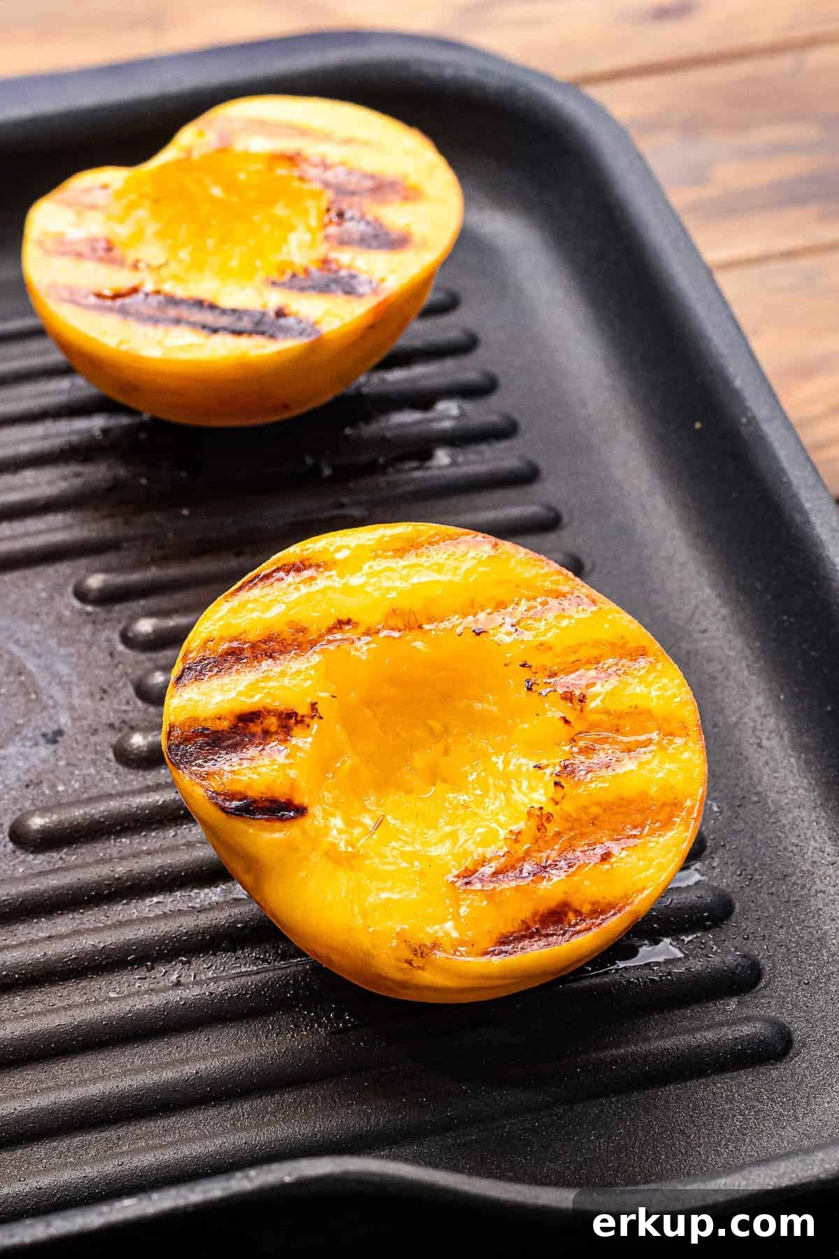 Peaches with grill marks laying on grill pan