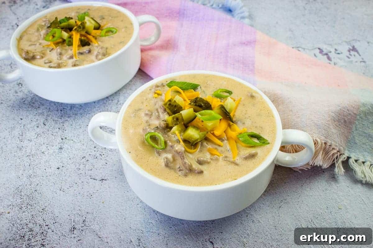 Cheeseburger soup in two serving bowls.