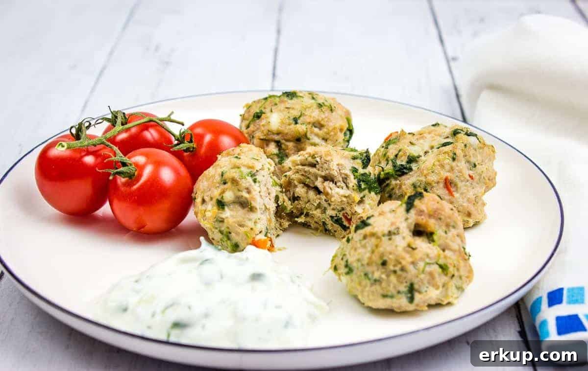 Greek Meatballs on a plate with tomatoes.