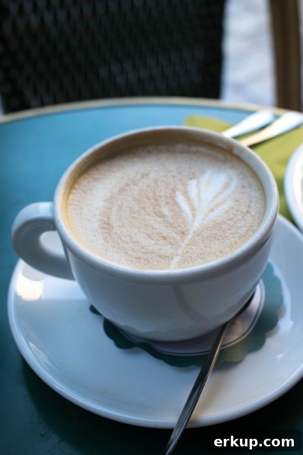 Greek Coffee: Your Guide to Coffee Culture in Greece 6 Cappuccino served in a lovely coffee cup and topped with a beautiful leaf.