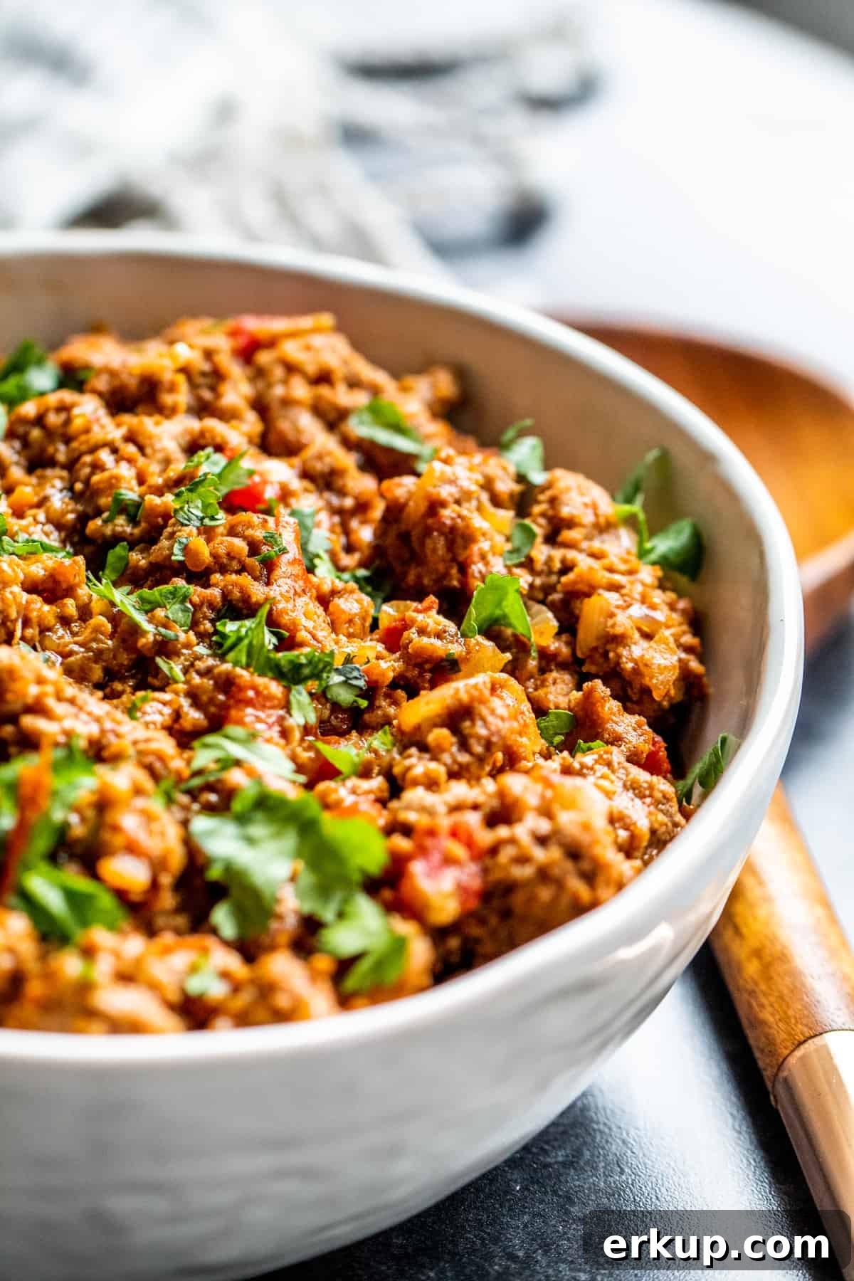 Angle shot of meat in white bowl.