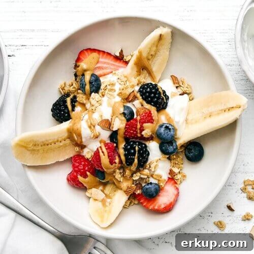 Breakfast banana split on a plate.